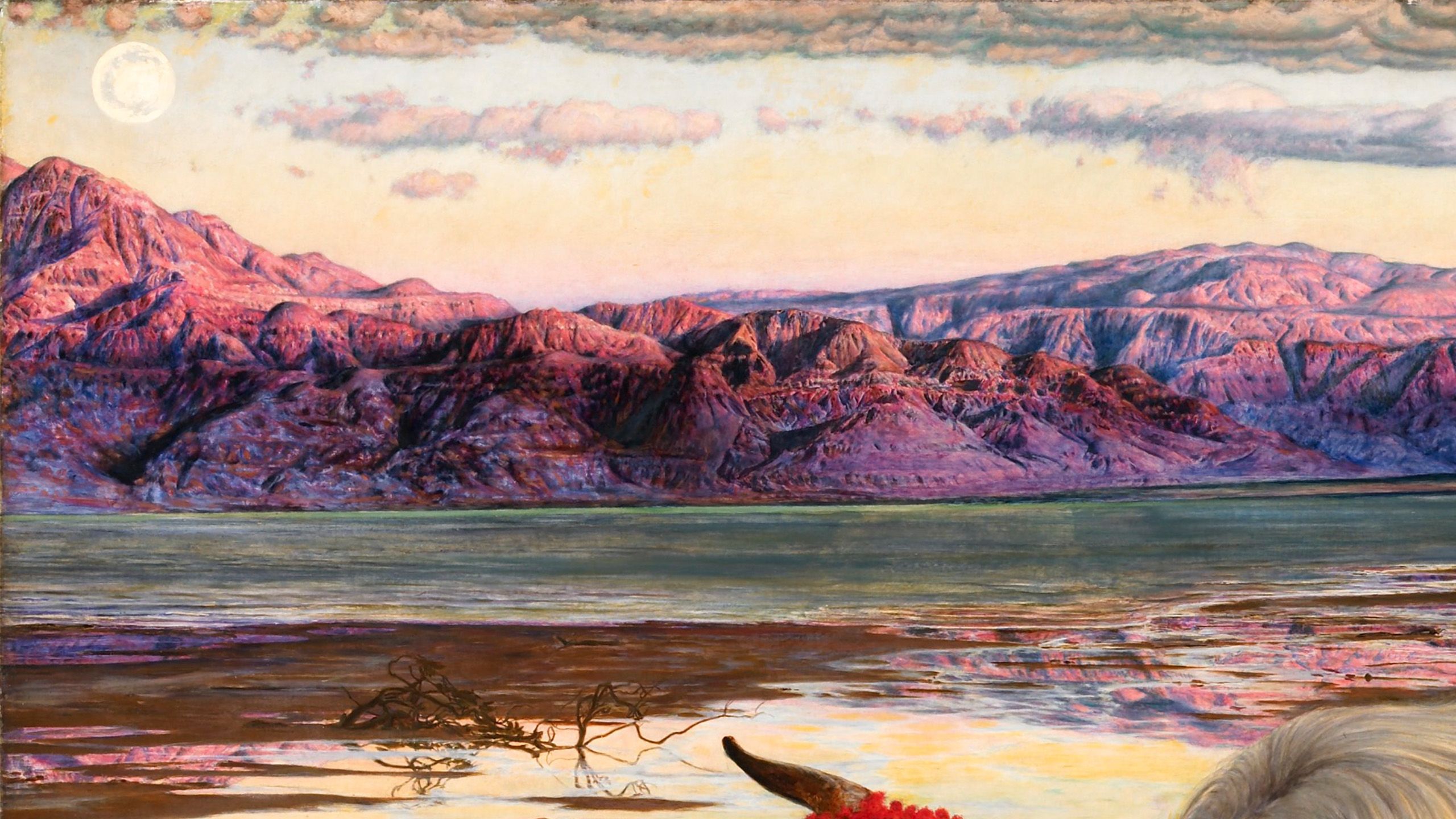 Vivid landscape with pink and purple mountains looming over a sea with a green hue
