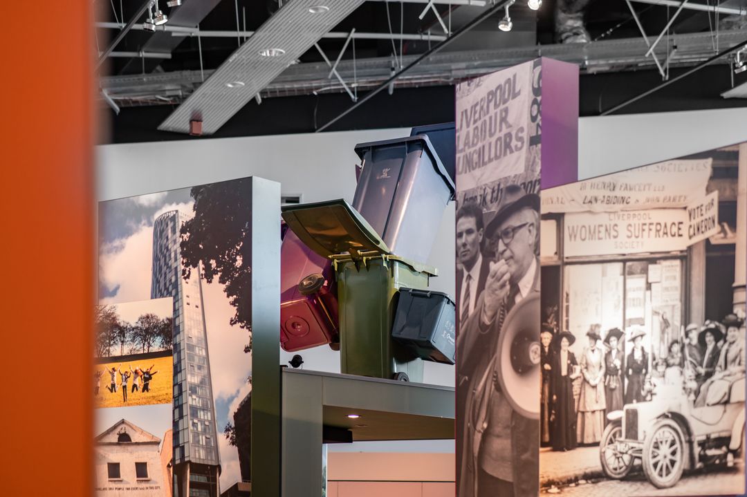 The People's Republic gallery with a stack of wheelie bins and a Suffragette display.